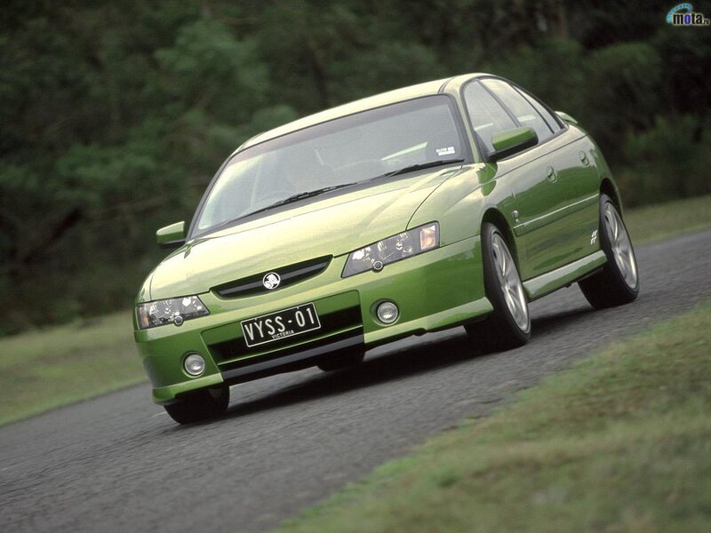 green sedan on a road