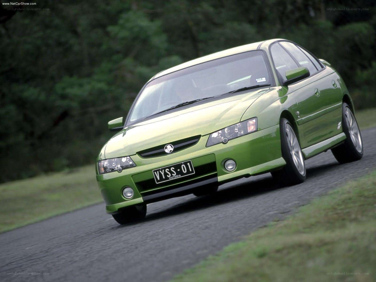 green sedan on a road