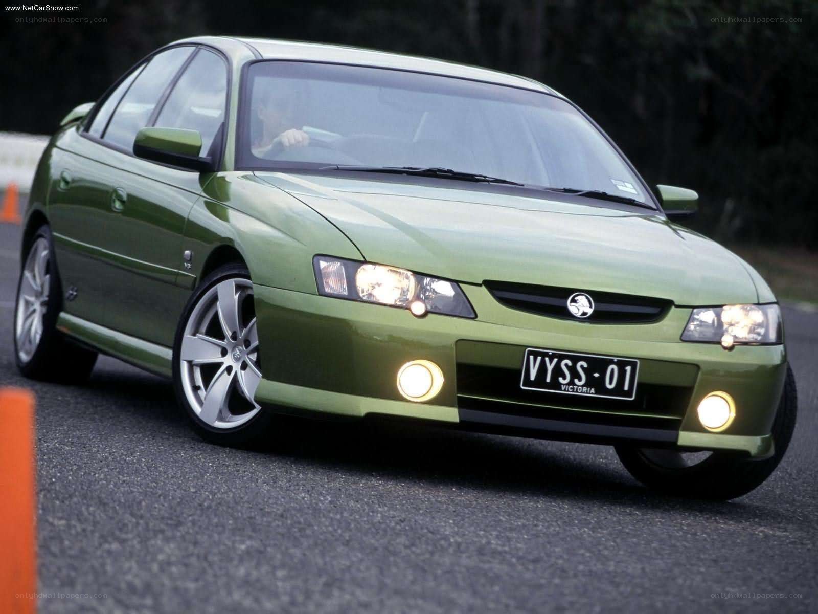 green sedan on a track