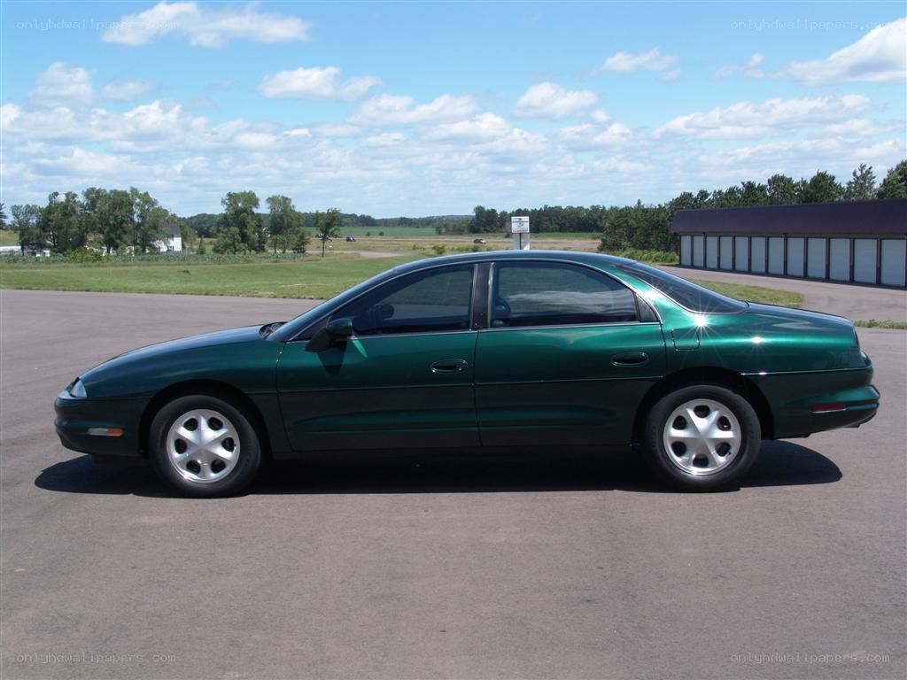 green sedan parked outdoors