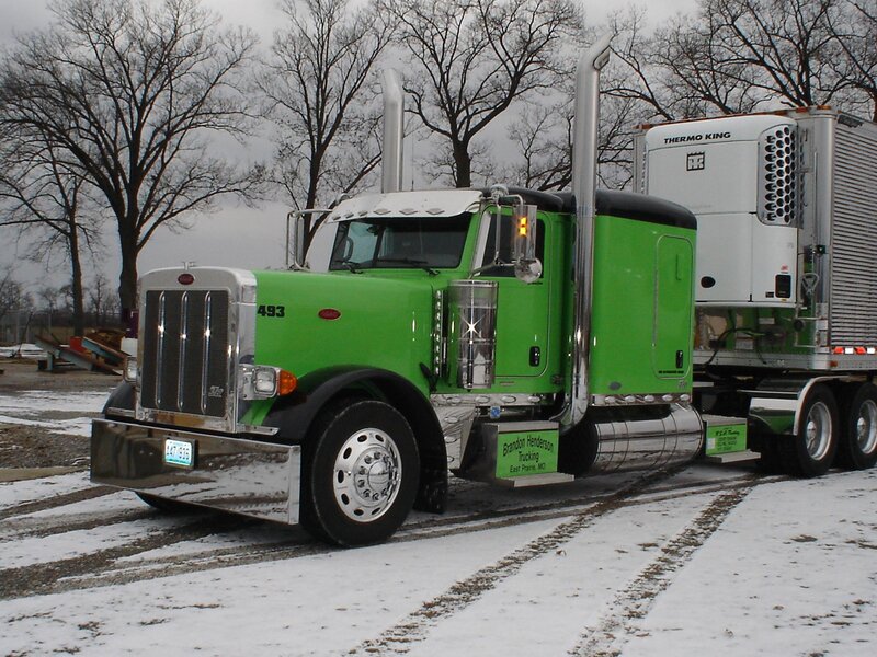 green semi-truck in snow