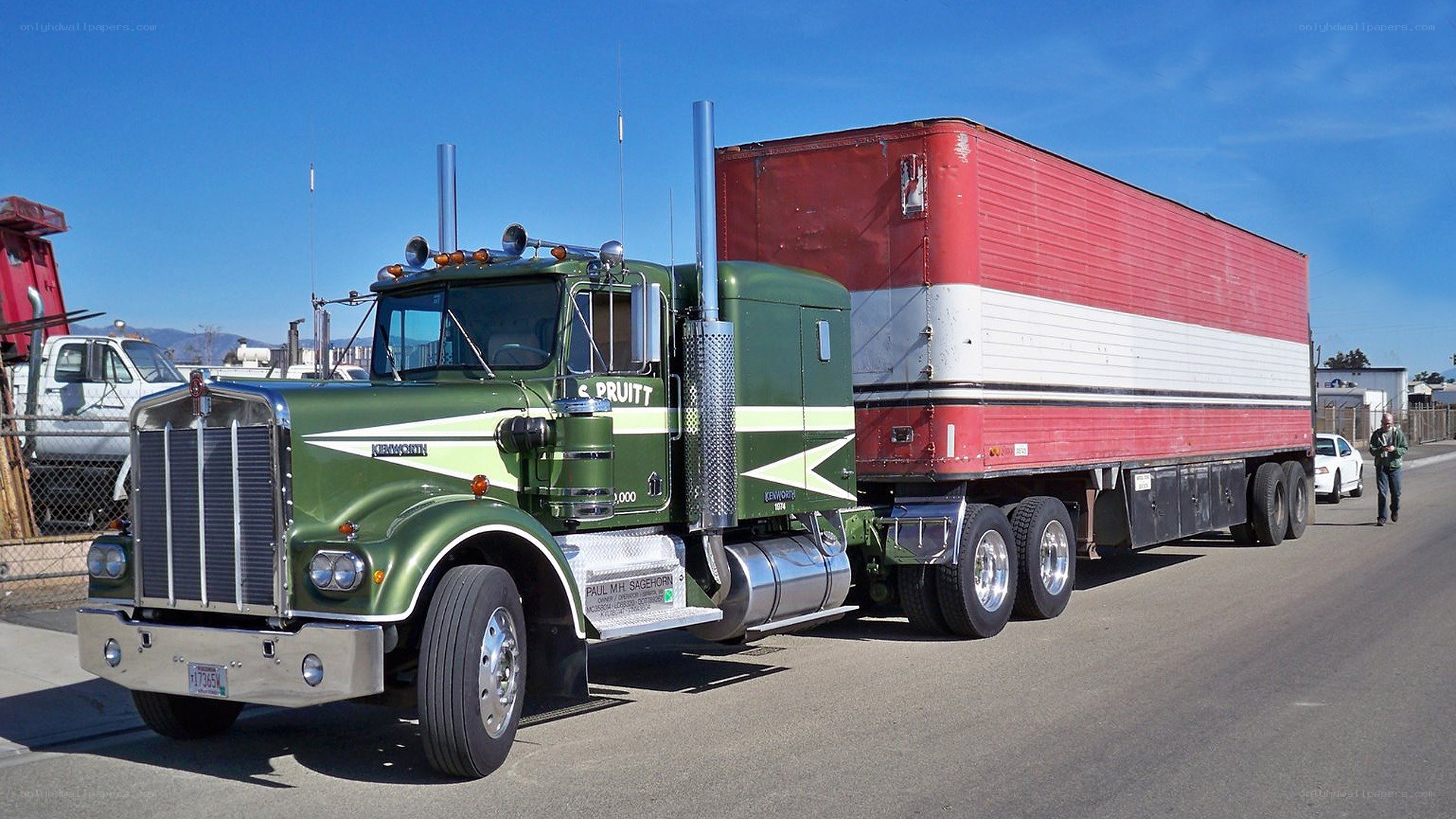 green semi-truck with red trailer
