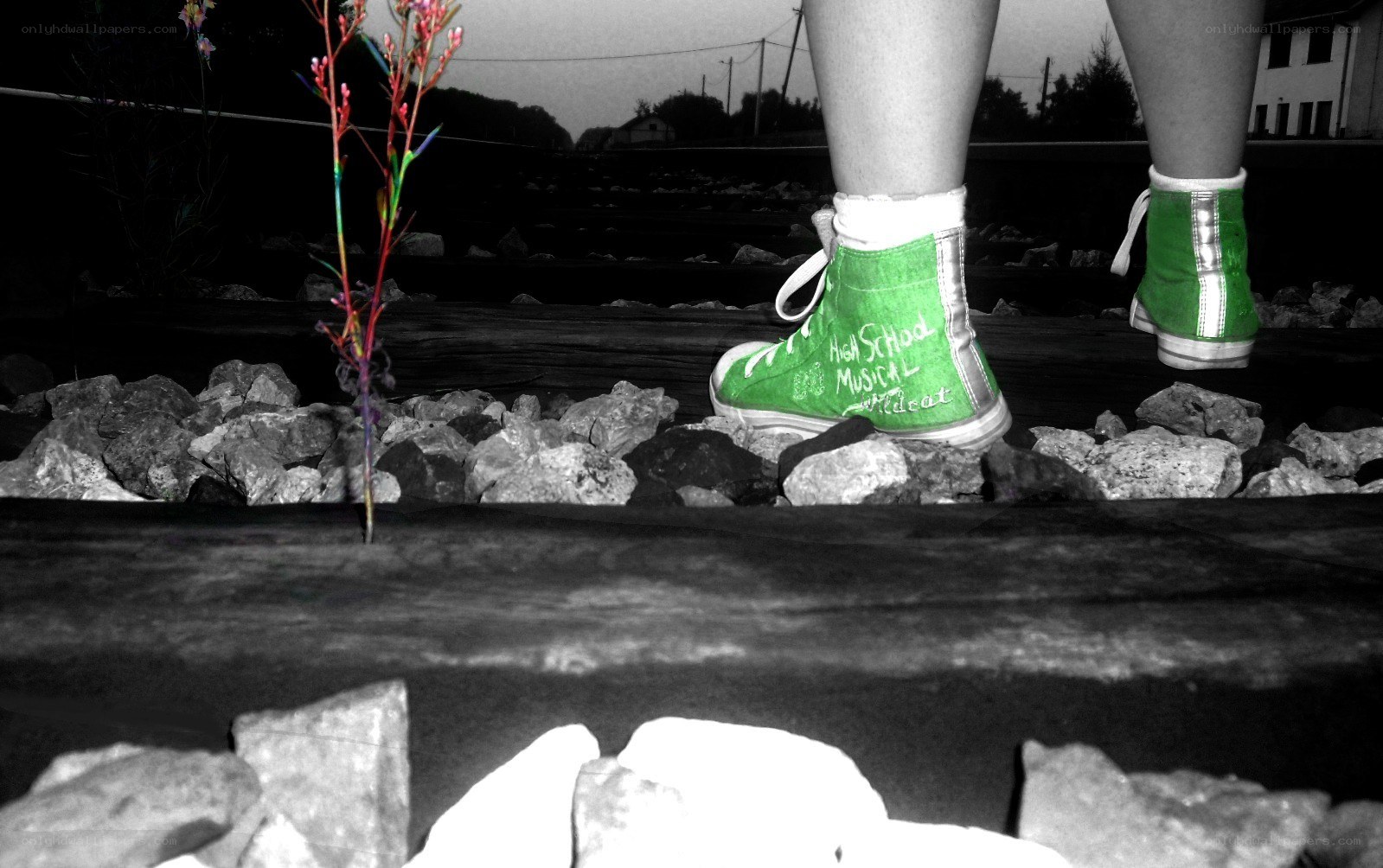 green shoes on train tracks