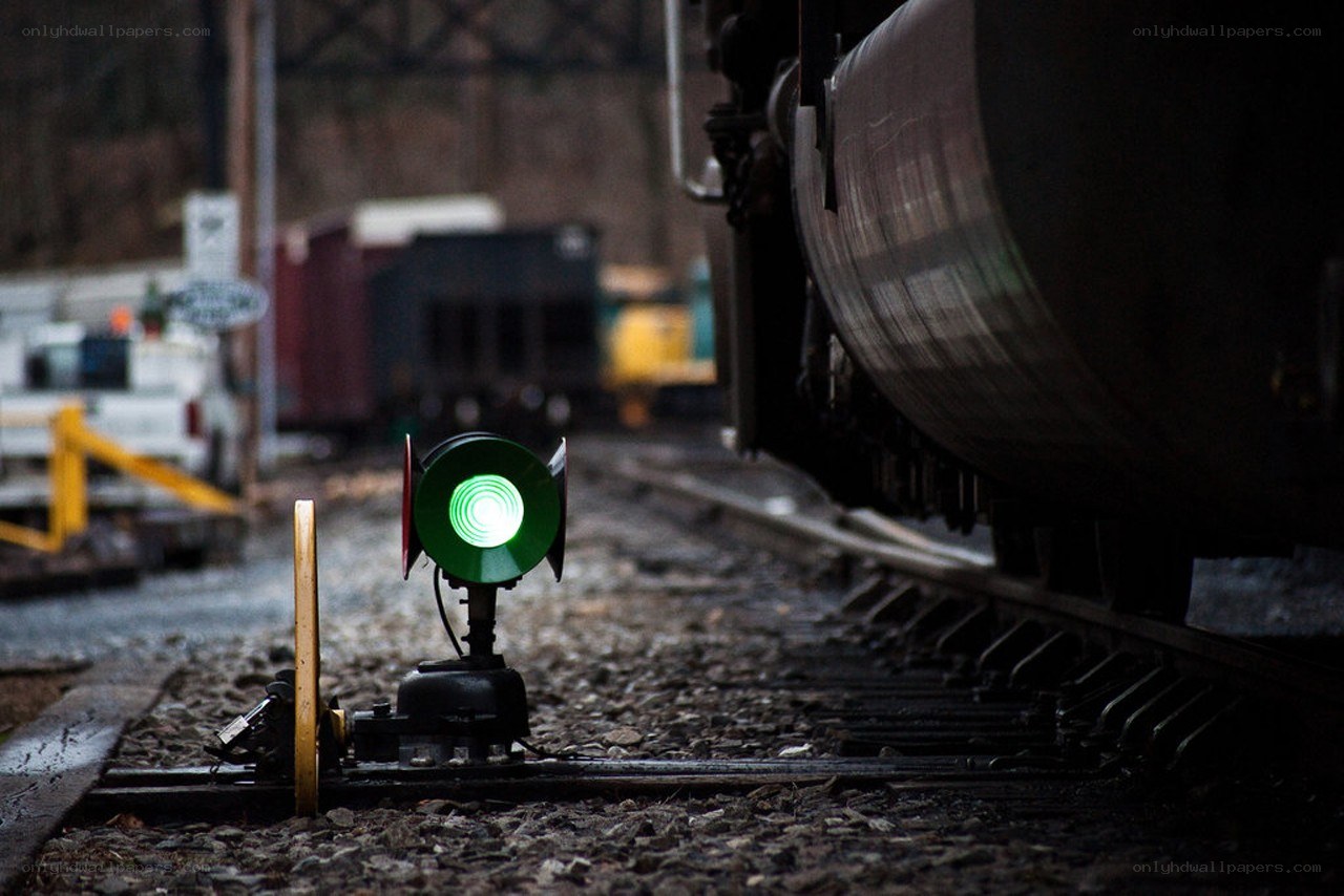 Green signal light on train tracks