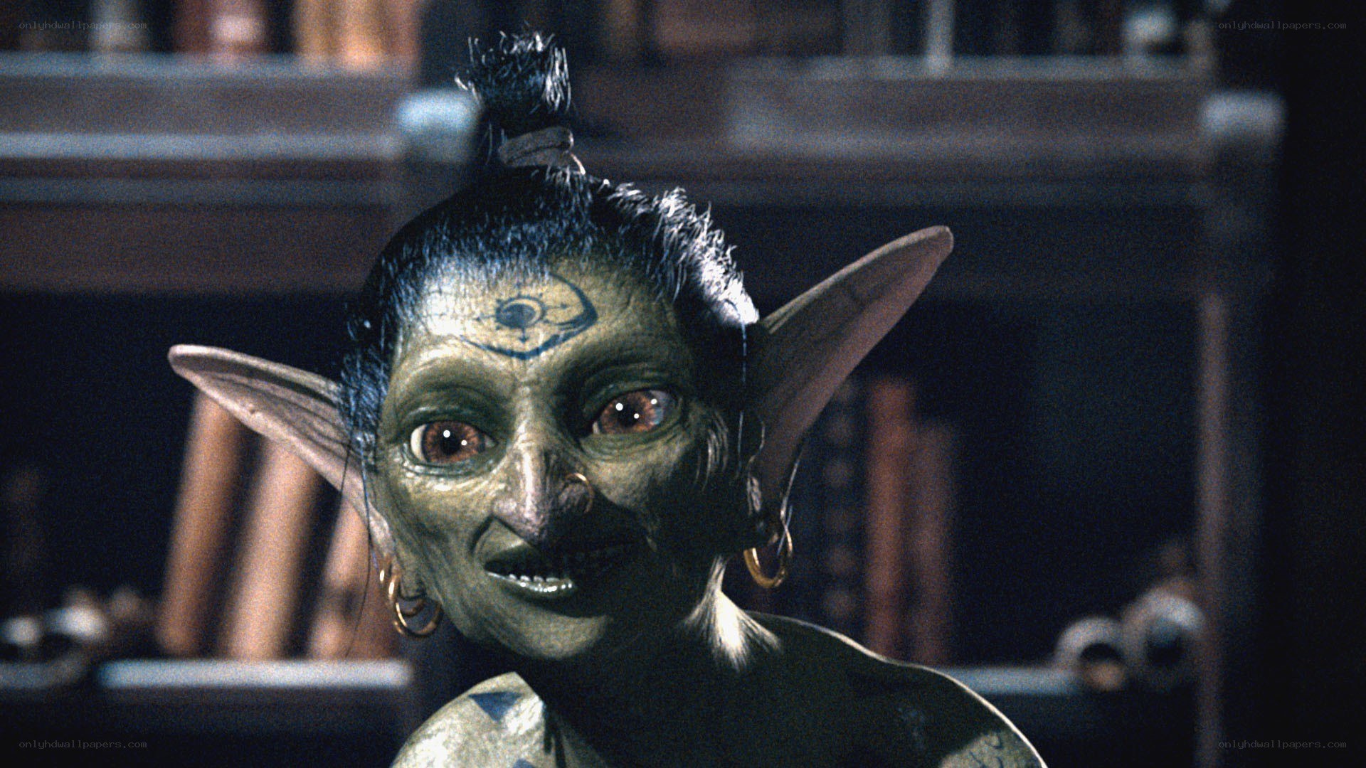 green-skinned creature with tattoos