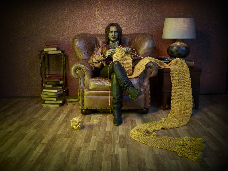 green-skinned knitter in armchair