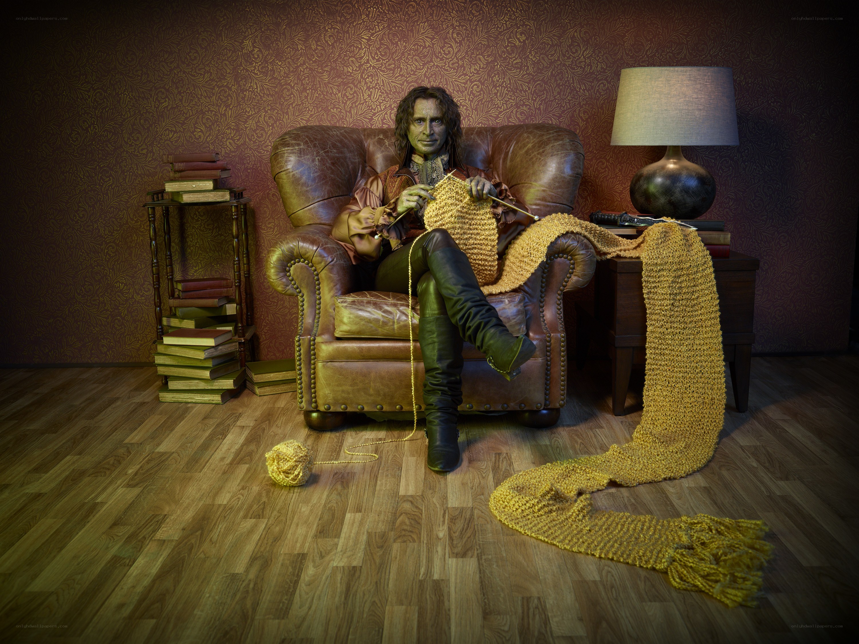 green-skinned knitter in armchair