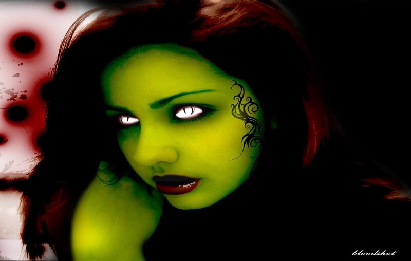 green-skinned woman with glowing eyes