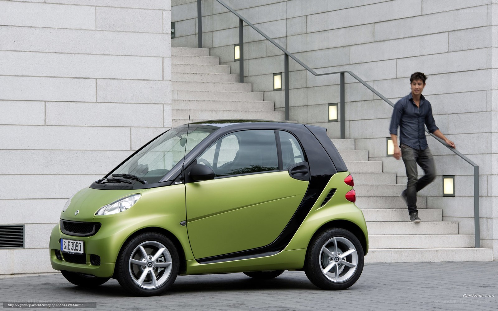 Green smart car on city street