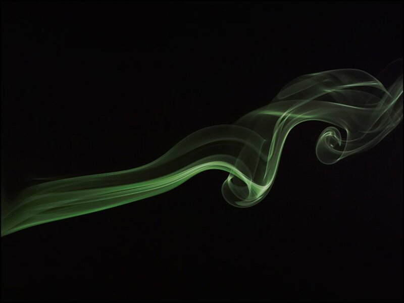 Green smoke swirl on black