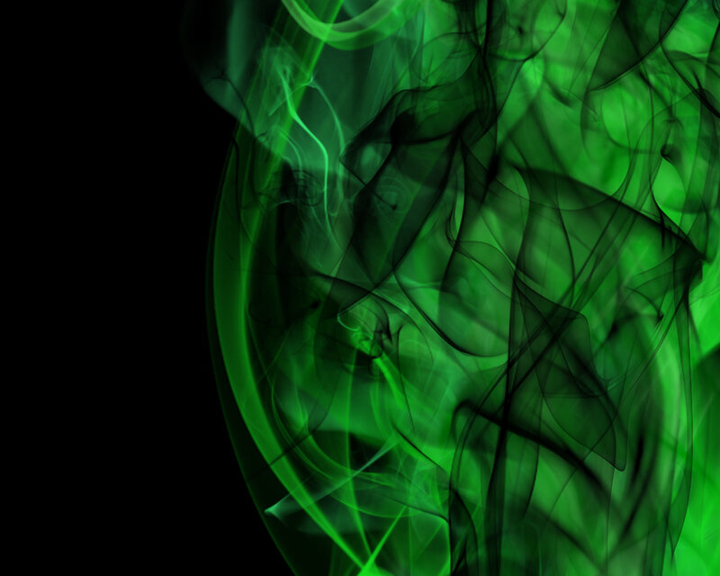 green smoke swirls on black
