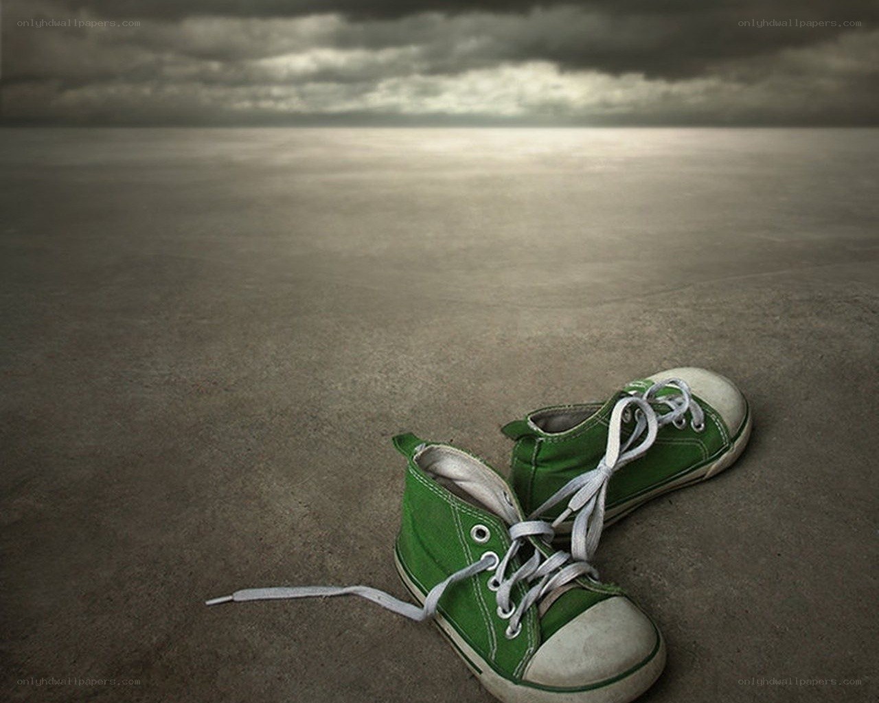 Green sneakers on empty ground