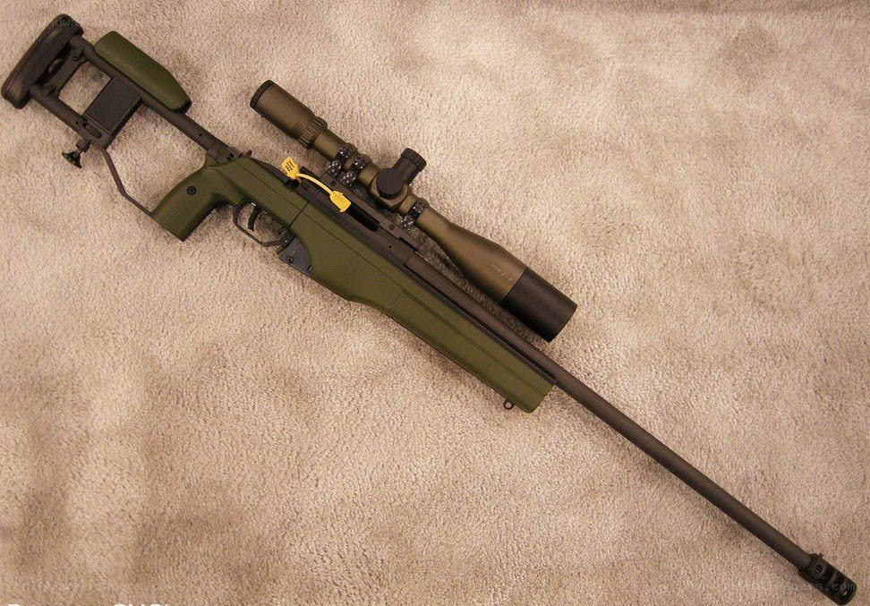 green sniper rifle with scope