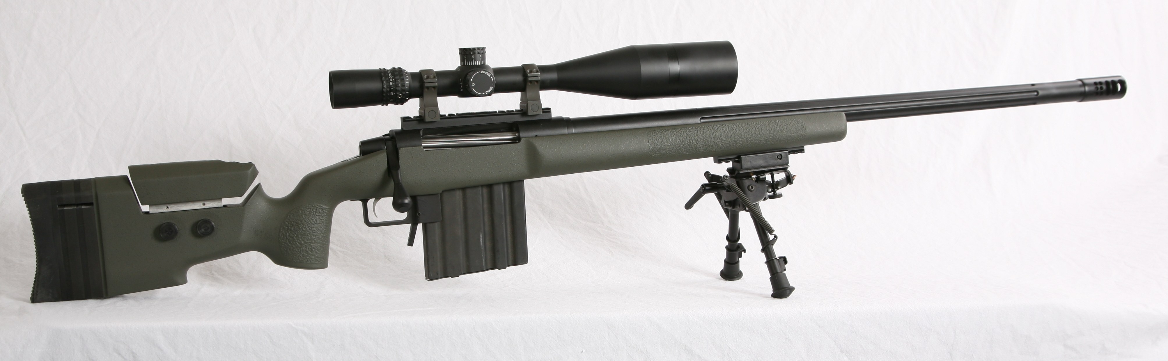 green sniper rifle with scope