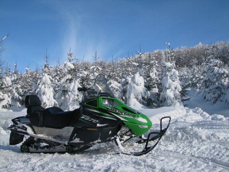 Green Snowmobile in Snow