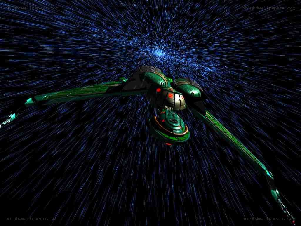 green spaceship in warp speed