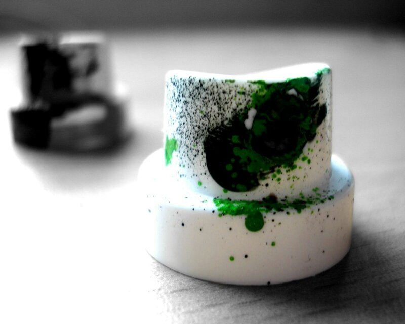 green-splattered paint cap