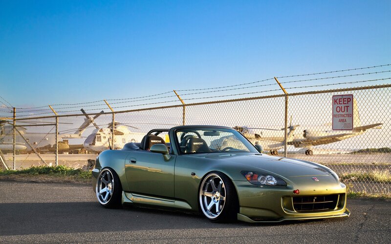 Green sports car at airfield