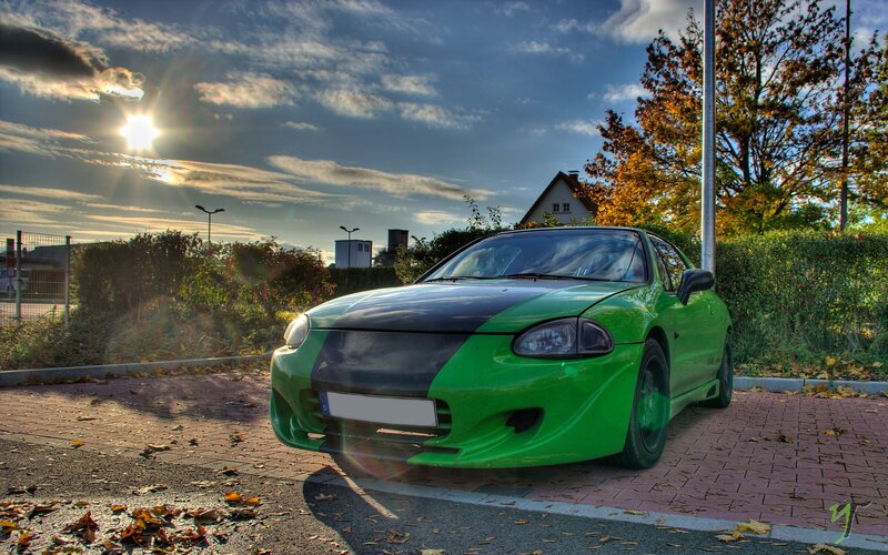 green sports car at sunset