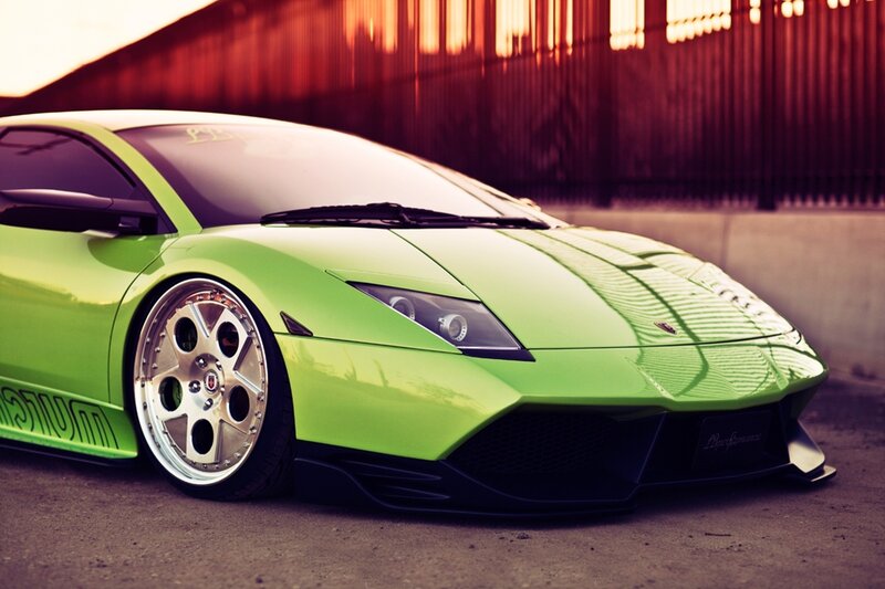green sports car at sunset
