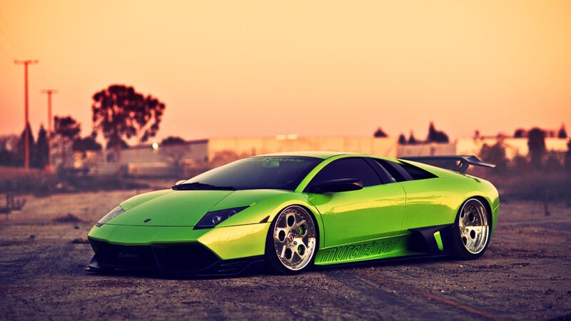 green sports car at sunset