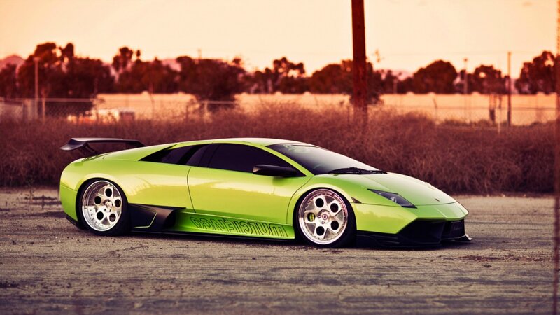 green sports car at sunset