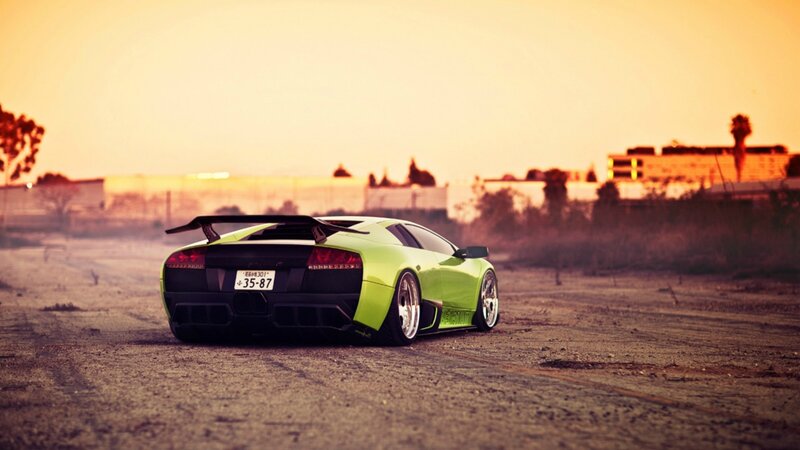 green sports car at sunset