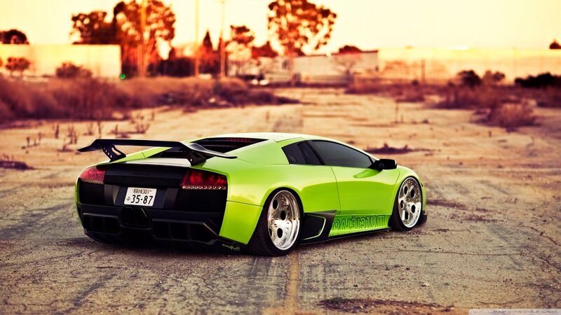 green sports car at sunset