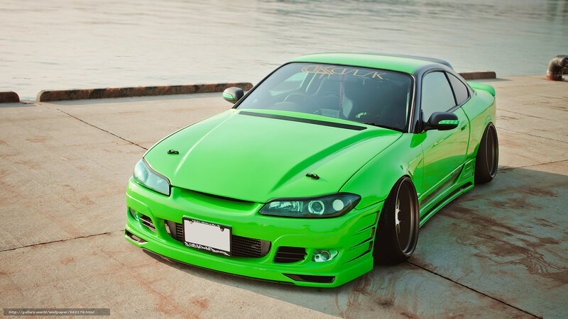 green sports car by water