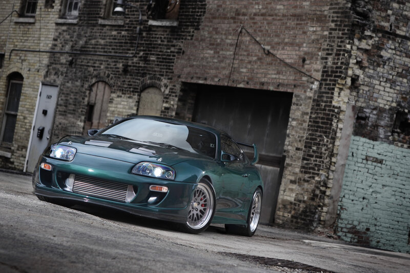Green Sports Car — Dramatic, Afternoon, Photograph, Brick Building