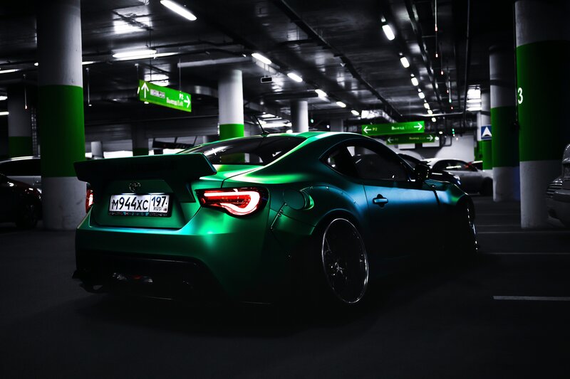 Green Sports Car — Dramatic, Night, Photograph, Parking Garage, Lights