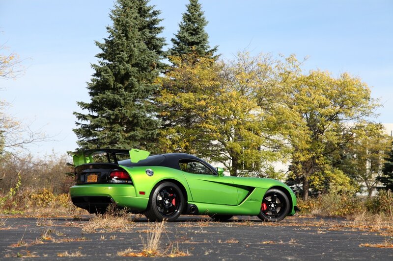 Green sports car in autumn