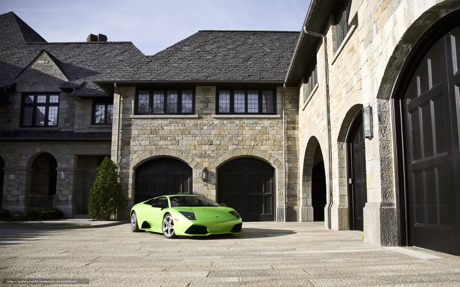 green sports car in driveway