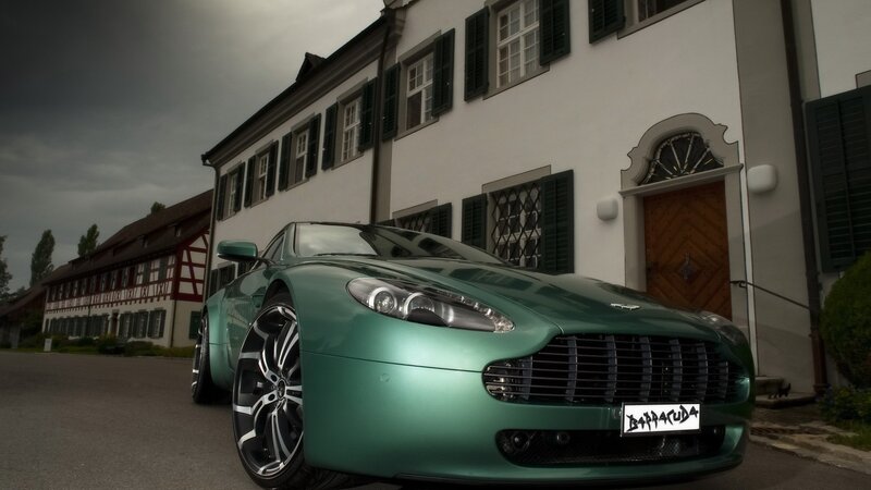 green sports car in front of building