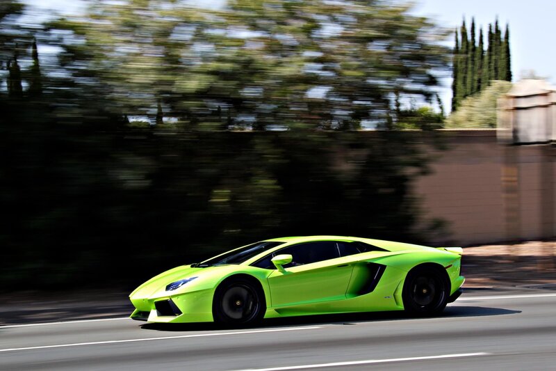 green sports car in motion