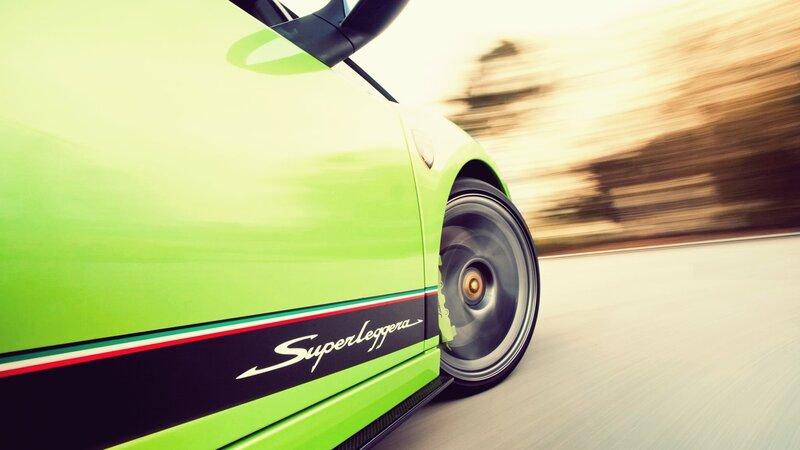 green sports car in motion