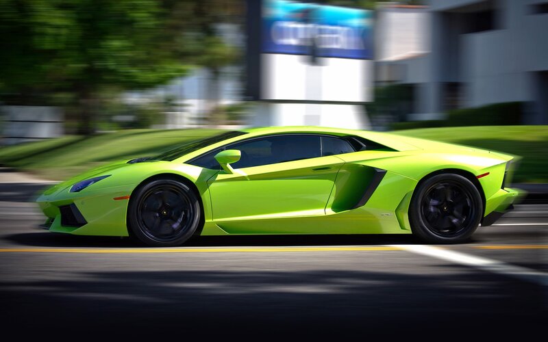 green sports car in motion