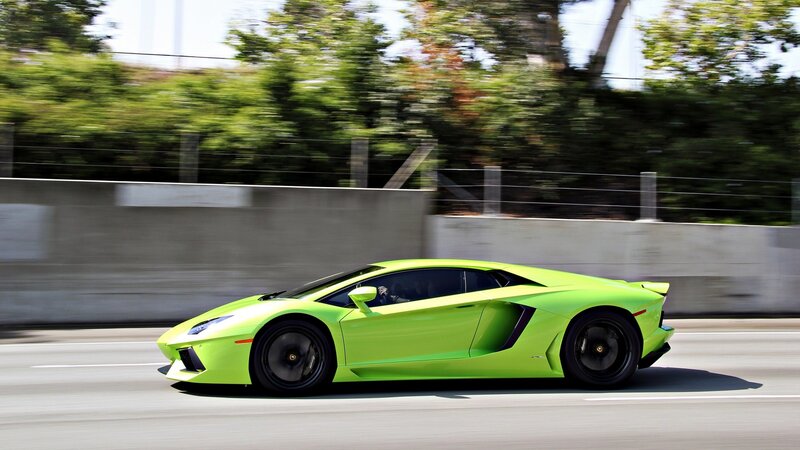 green sports car in motion