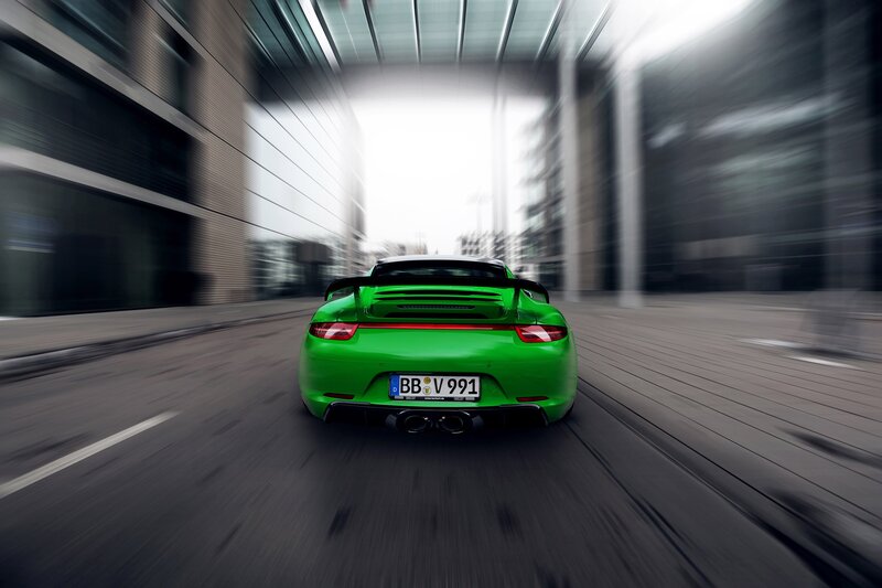 Green sports car in motion