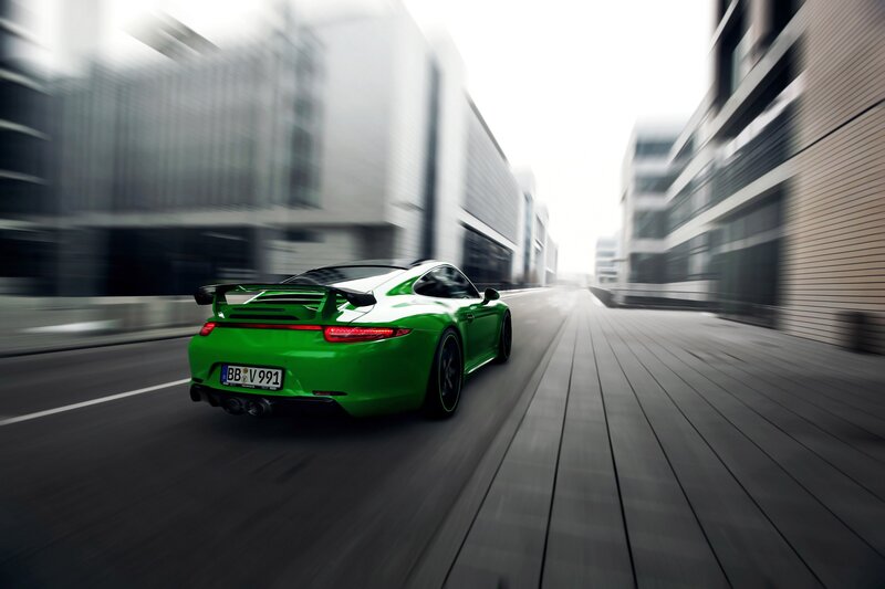 green sports car in motion