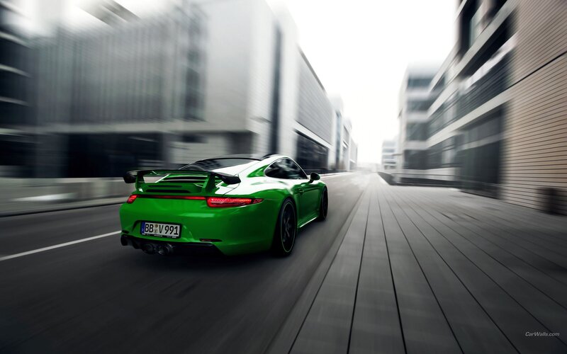 green sports car in motion