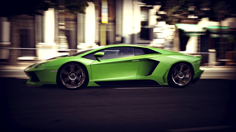 green sports car in motion
