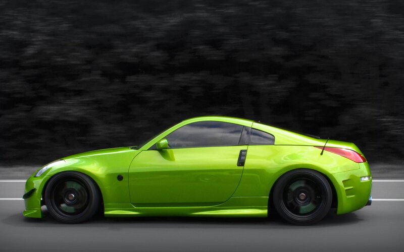 green sports car in motion