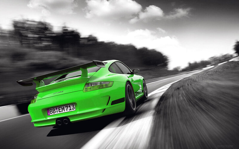 green sports car in motion