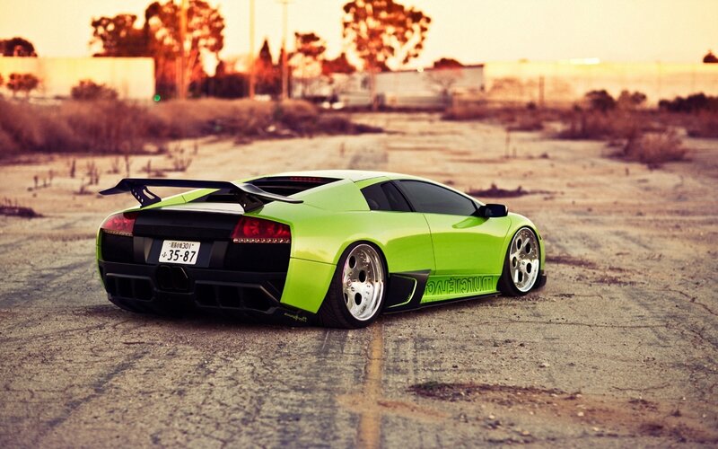 green sports car in parking lot