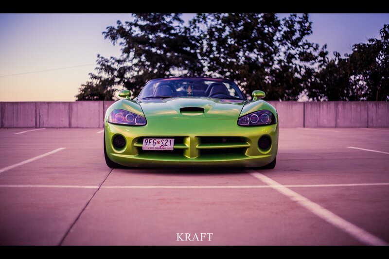 green sports car in parking lot