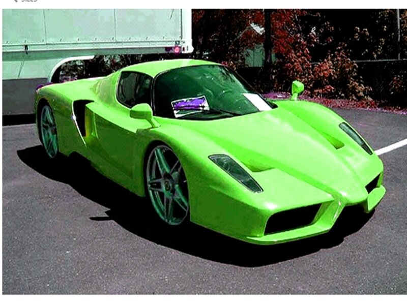 green sports car in parking lot