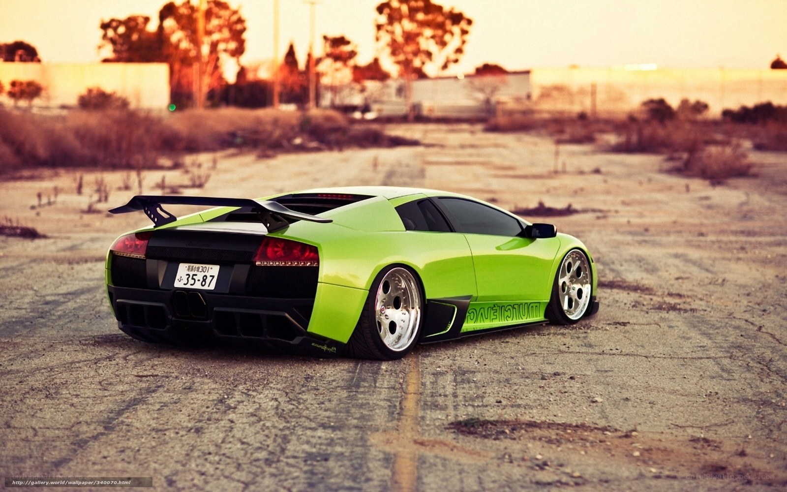 green sports car in parking lot