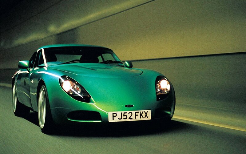 green sports car in tunnel