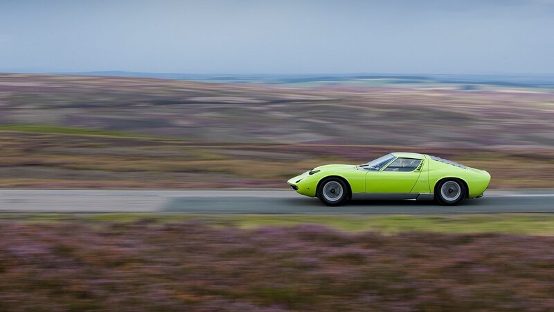 Green sports car on a road